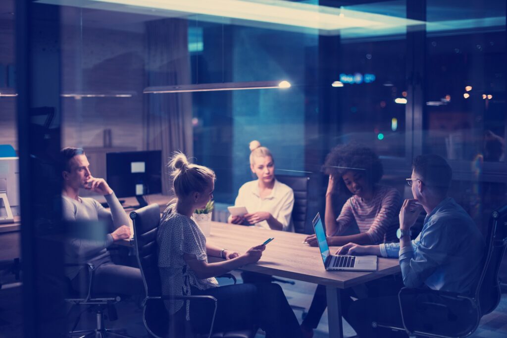 Multiethnic startup business team in night office